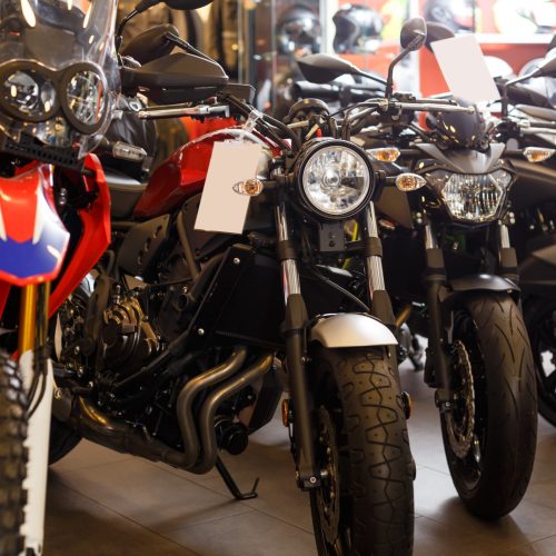 View of range new motorcycles parked in showroom for sale at motosalon